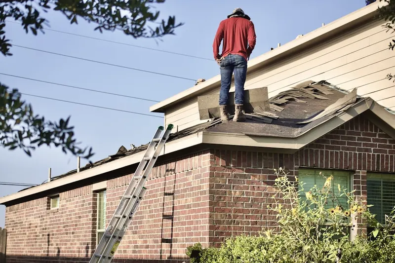 Professional roofer working on a residential roof in Penn Farms